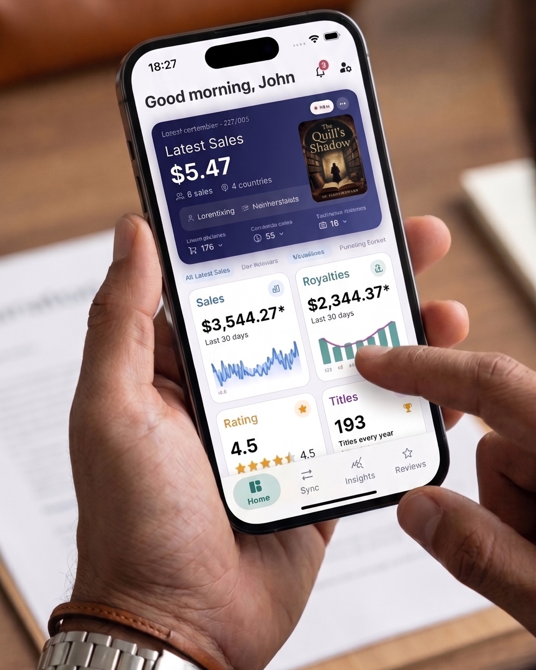 A royalty tracking spreadsheet next to the TrackingInk app.